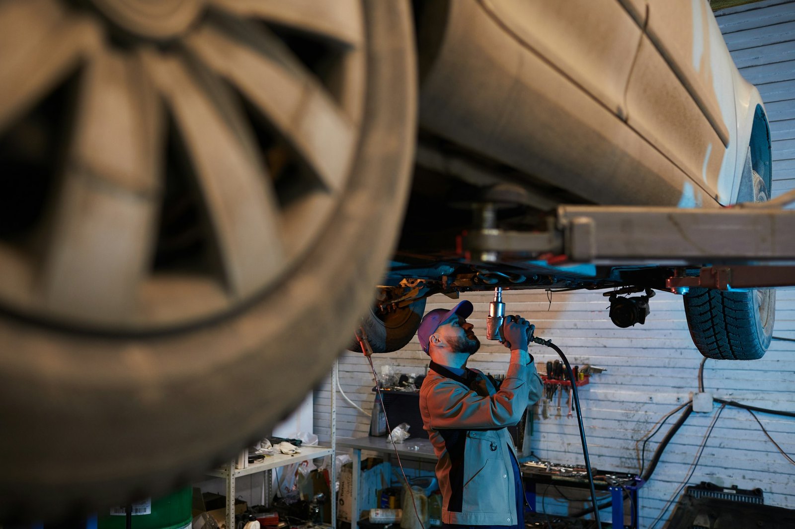 Auto Mechanic Working Under Car